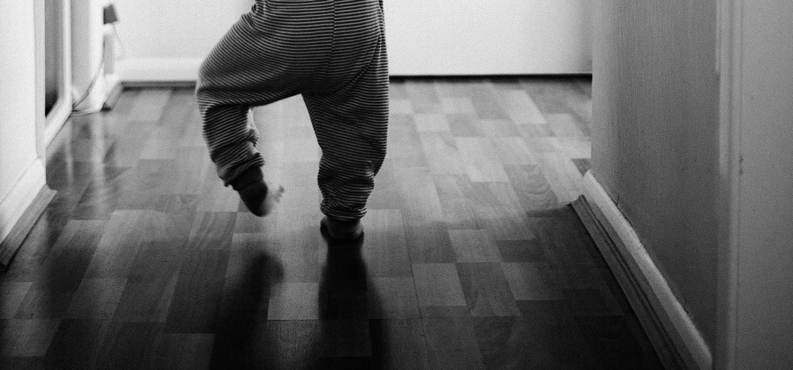 Baby learning to walk slipping on hard floor